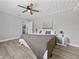 Bedroom with ceiling fan, wood-look floors, and ensuite bath at 501 15Th Ne Ct, Winter Haven, FL 33881