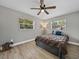 Bedroom with neutral walls, ceiling fan, and two windows that provide natural light at 501 15Th Ne Ct, Winter Haven, FL 33881