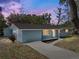 Charming single-story home with blue brick and well-maintained landscaping at dusk at 501 15Th Ne Ct, Winter Haven, FL 33881