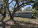 Charming home exterior showcasing mature trees, a neatly kept lawn, and a brick facade at 501 15Th Ne Ct, Winter Haven, FL 33881