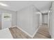 Hallway with white door and wood-look floors at 501 15Th Ne Ct, Winter Haven, FL 33881