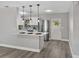 Modern kitchen with stainless steel appliances, white cabinets, and bar seating at 501 15Th Ne Ct, Winter Haven, FL 33881