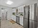 Kitchen featuring stainless steel appliances, shaker cabinets, and a laundry area at 501 15Th Ne Ct, Winter Haven, FL 33881