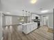 Open kitchen and living area with island, stainless appliances, and natural light at 501 15Th Ne Ct, Winter Haven, FL 33881