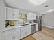 Bright kitchen featuring white cabinets, stainless steel appliances, and quartz countertops at 501 15Th Ne Ct, Winter Haven, FL 33881