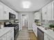 Modern kitchen with white cabinets, stainless steel appliances, and subway tile backsplash at 501 15Th Ne Ct, Winter Haven, FL 33881