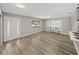 Light-filled living room with wood-look floors and built-in shelving at 501 15Th Ne Ct, Winter Haven, FL 33881