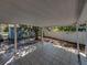 View of a tiled covered patio overlooking the backyard and shed with flowering trees at 501 15Th Ne Ct, Winter Haven, FL 33881