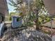 Backyard shed surrounded by flowering trees and a small paver patio at 501 15Th Ne Ct, Winter Haven, FL 33881