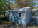 Backyard shed featuring painted siding and a 'Beware of Dog' sign at 501 15Th Ne Ct, Winter Haven, FL 33881