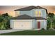 Charming two-story home with a two-car garage, lush lawn, and landscaped front yard at 1062 Silverlake Blvd, Lake Alfred, FL 33850