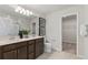 Bright bathroom with double vanity, modern fixtures, and walk-in closet for extra storage at 1423 Hamilton Way, Lake Alfred, FL 33850