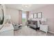 Bedroom with a black crib, pink accents, and a window offering a pleasant view of the outdoors at 1431 Hamilton Way, Lake Alfred, FL 33850
