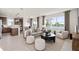 Inviting living room featuring stylish furniture, neutral tones, large windows, and scenic water views at 1431 Hamilton Way, Lake Alfred, FL 33850