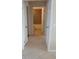 Hallway view of the bathroom featuring tiled floor, a tiled tub and a toilet at 308 Summer Field Dr, Winter Haven, FL 33880