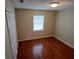 Cozy bedroom featuring gleaming hardwood floors, a closet and natural light from the window at 308 Summer Field Dr, Winter Haven, FL 33880