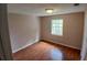This cozy bedroom features warm paint, hardwood floors, and a window that allows for plenty of natural light at 308 Summer Field Dr, Winter Haven, FL 33880