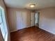 This light-filled bedroom features a closet, hardwood floors, and neutral walls perfect for creating a relaxing retreat at 308 Summer Field Dr, Winter Haven, FL 33880