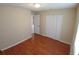 A cozy bedroom featuring beautiful hardwood floors and a spacious closet with bi-fold doors at 308 Summer Field Dr, Winter Haven, FL 33880