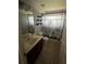 Cozy bathroom with tile flooring, vanity, shelving, and a cat themed shower curtain at 3035 Buckeye Pointe Dr, Winter Haven, FL 33881