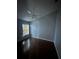 Well-lit bedroom with hardwood floors, a ceiling fan, and a window providing natural light and ventilation at 3035 Buckeye Pointe Dr, Winter Haven, FL 33881