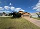 Inviting single-Gathering home with attached garage, mature landscaping, and a well-manicured front lawn at 3035 Buckeye Pointe Dr, Winter Haven, FL 33881
