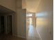 Tiled hallway with partial view of the front door, offering a glimpse of the exterior at 3035 Buckeye Pointe Dr, Winter Haven, FL 33881