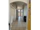 Hallway featuring archways, tile flooring, and a view of the front door at the end of the hall at 3035 Buckeye Pointe Dr, Winter Haven, FL 33881