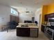 Open floor plan featuring a kitchen island with sink, appliances, and seamless access to the living area at 3035 Buckeye Pointe Dr, Winter Haven, FL 33881