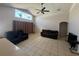 Bright living room features tile flooring and a modern ceiling fan; seamlessly connects to an open-concept layout at 3035 Buckeye Pointe Dr, Winter Haven, FL 33881
