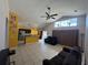 Spacious living room featuring tile flooring and modern ceiling fan, seamlessly connects to an open-concept kitchen at 3035 Buckeye Pointe Dr, Winter Haven, FL 33881