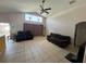 Bright living room with tile flooring, vaulted ceiling, and a large window offering lots of natural light at 3035 Buckeye Pointe Dr, Winter Haven, FL 33881