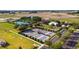 Aerial view of community recreation area featuring tennis, pickleball, and bocce ball courts and event lawn at 6898 Sw 95Th Cir, Ocala, FL 34481