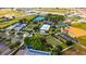 Aerial view showcasing recreational facilities featuring tennis courts, bocce ball, event lawn, and parking at 6898 Sw 95Th Cir, Ocala, FL 34481