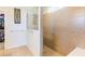 A beautifully tiled walk-in shower is featured next to a walk-in closet at 6898 Sw 95Th Cir, Ocala, FL 34481