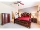 Comfortable bedroom with a ceiling fan, carpet, lamps, and dressers for storage at 6898 Sw 95Th Cir, Ocala, FL 34481