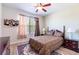 Relaxing bedroom with a ceiling fan, natural light and a floral area rug at 6898 Sw 95Th Cir, Ocala, FL 34481