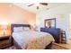 Bedroom with carpet, ceiling fan, lamps, dresser and a double bed at 6898 Sw 95Th Cir, Ocala, FL 34481