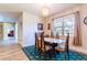 Bright dining room featuring a chandelier, area rug, and a table with seating for six at 6898 Sw 95Th Cir, Ocala, FL 34481