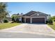 Beautiful single-story home with a well-maintained lawn and a three-car garage at 6898 Sw 95Th Cir, Ocala, FL 34481