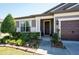 Charming home featuring a well-manicured front yard, neutral colors, and a covered front entryway at 6898 Sw 95Th Cir, Ocala, FL 34481