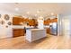 Well-lit kitchen featuring a central island, stainless steel appliances, ample cabinet space, and an open design at 6898 Sw 95Th Cir, Ocala, FL 34481
