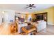 Expansive living area featuring an open layout, wood-look flooring, comfortable seating, and access to other living spaces at 6898 Sw 95Th Cir, Ocala, FL 34481