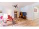 Inviting living room with a cozy seating area, entertainment center, and light wood-look flooring throughout at 6898 Sw 95Th Cir, Ocala, FL 34481