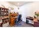 Home office with carpet, vintage desk, rolling chair, and wall mounted bookcase at 6898 Sw 95Th Cir, Ocala, FL 34481