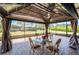 Outdoor patio with table and chairs, ideal for entertaining or enjoying the serene views at 6898 Sw 95Th Cir, Ocala, FL 34481