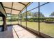 Screened in patio with brick floors and lovely views of the well maintained back yard at 6898 Sw 95Th Cir, Ocala, FL 34481