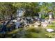 Serene water feature with a statue and lush landscaping in Stone Creek community at 6898 Sw 95Th Cir, Ocala, FL 34481