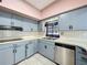 Traditional kitchen featuring ample counter space, cabinetry, and a stainless steel dishwasher at 156 Plumosus Dr, Altamonte Springs, FL 32701