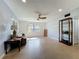 Spacious living room featuring neutral walls, ceiling fan and large windows providing natural light at 156 Plumosus Dr, Altamonte Springs, FL 32701